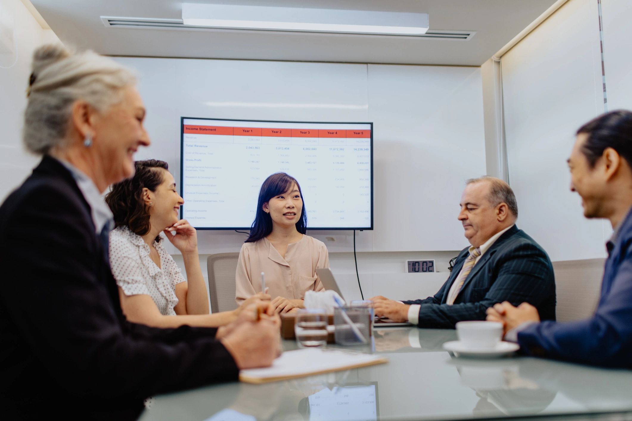 Advisor meeting with clients at a table reviewing documents